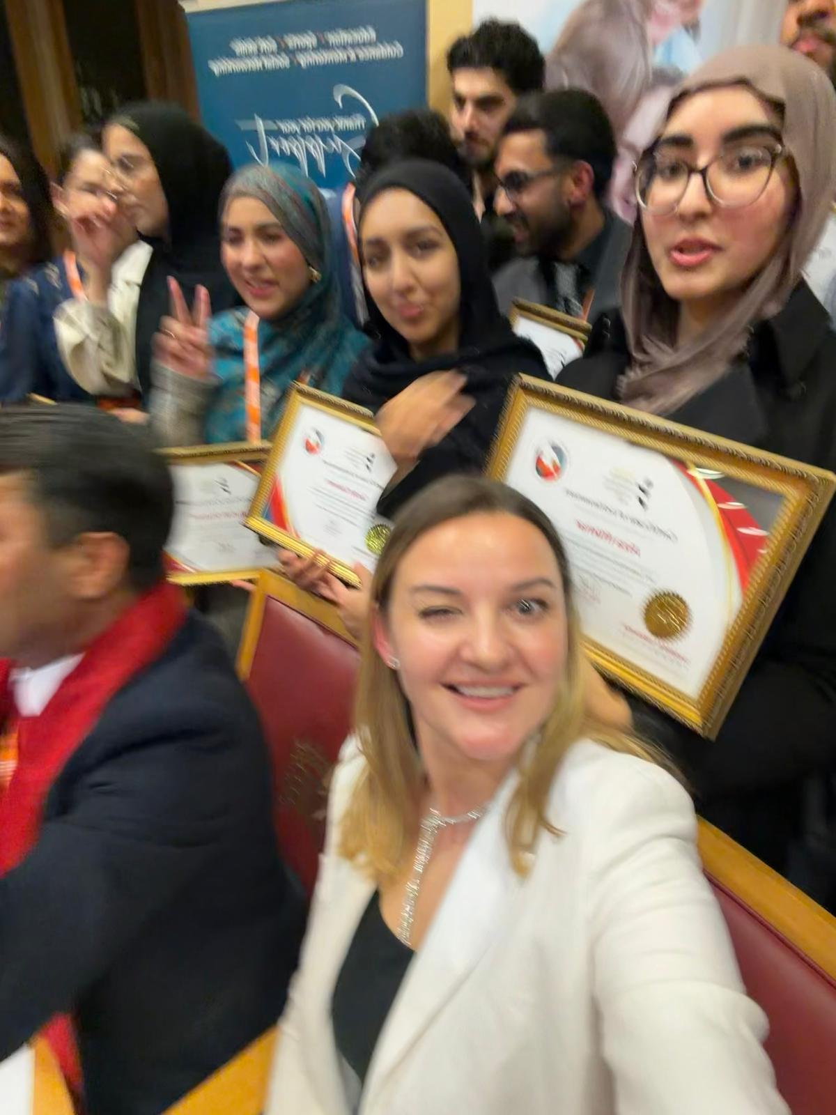 Kristina Culka with participants holding certificates after a charity programme