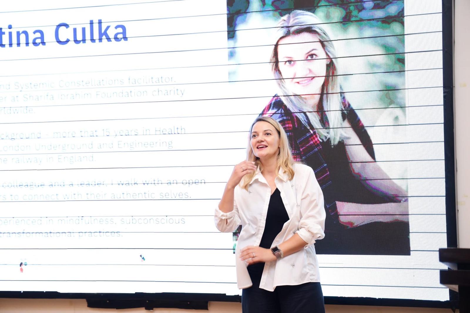 Kristina Culka speaking at a conference presentation connected with charity work