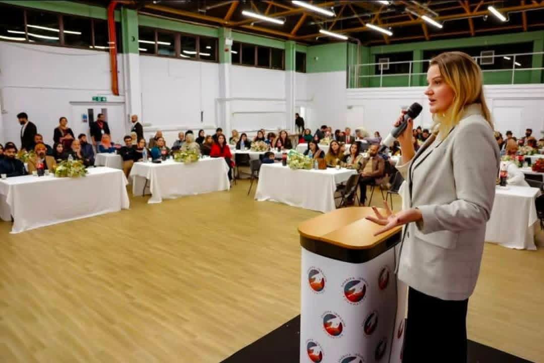 Kristina Culka speaking to an audience at a community charity event