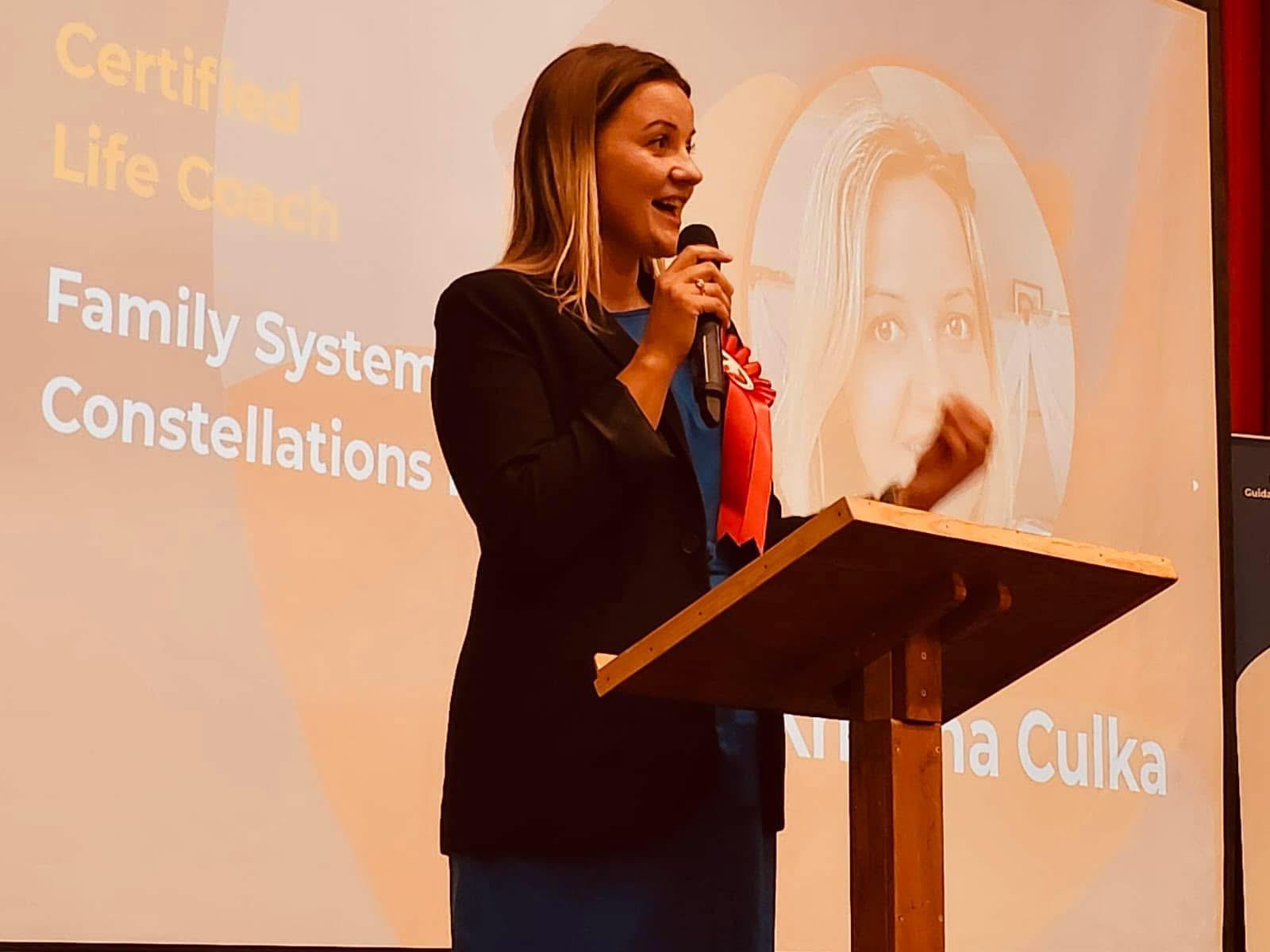 Kristina Culka speaking about family systemic constellations on stage