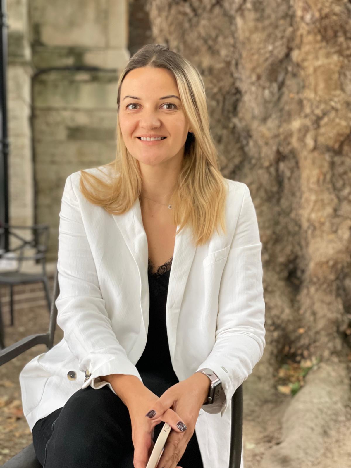 Kristina Culka seated outside in London for a calm professional portrait