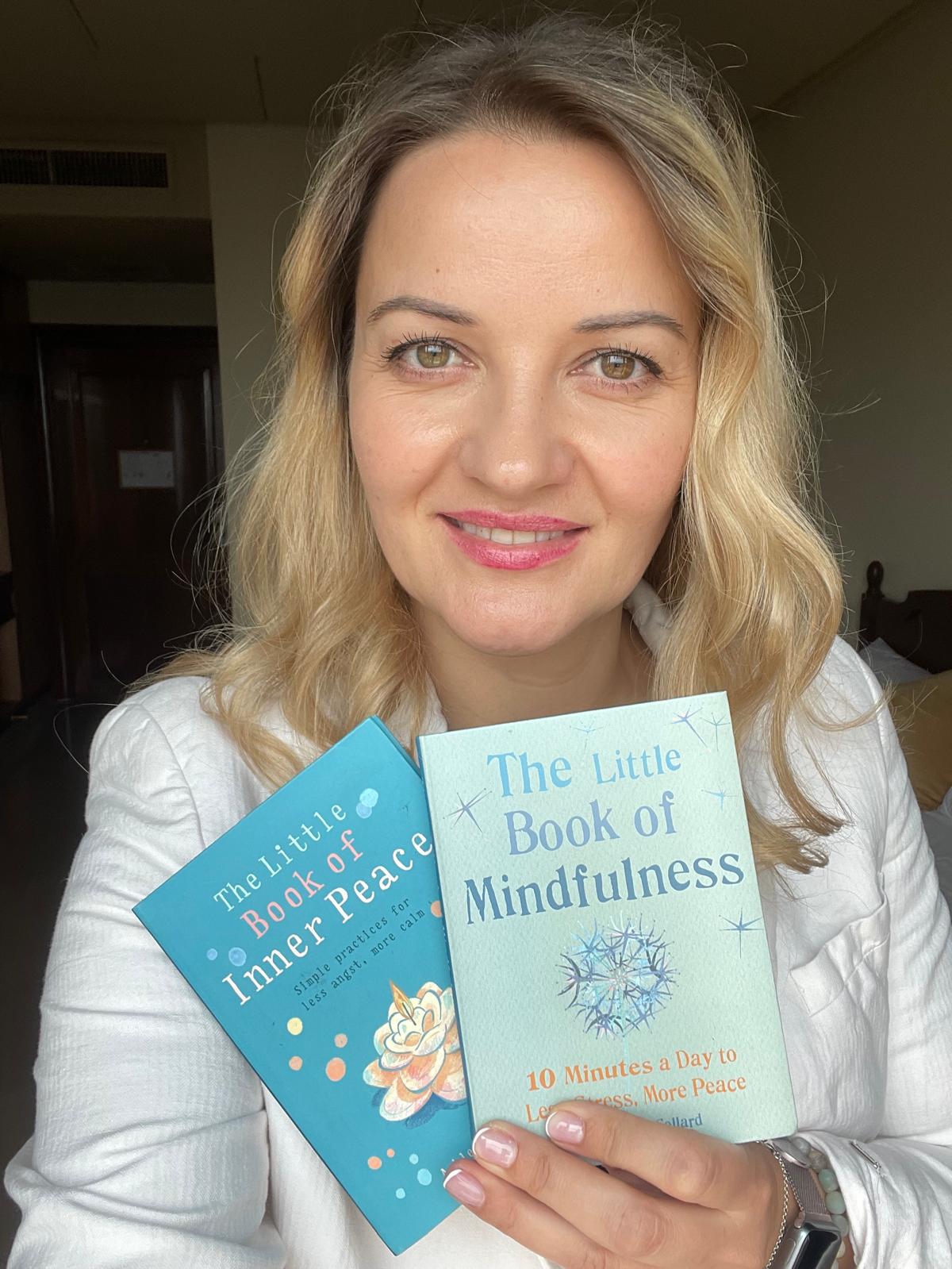 Kristina Culka holding mindfulness and inner peace books for reflective practice